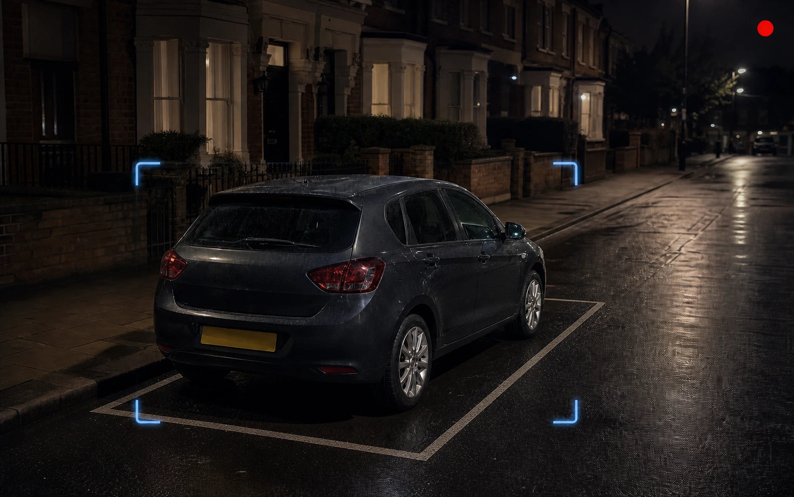 Parked car on a wet UK residential street at night with a subtle recording indicator